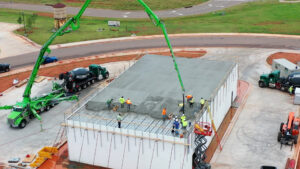 Installers pouring concrete on Super Floor system.