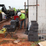 installer laying brick exterior on ICF project