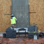 installer preparing exterior wall for brick laying