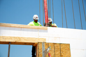 Installer pouring concrete into ICF wall