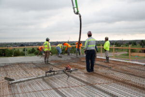 Installers pouring and screeding concrete on Super Floor system