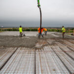 Workers pouring concrete on Super Floor system