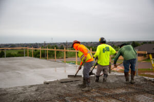 Workers screeding concrete